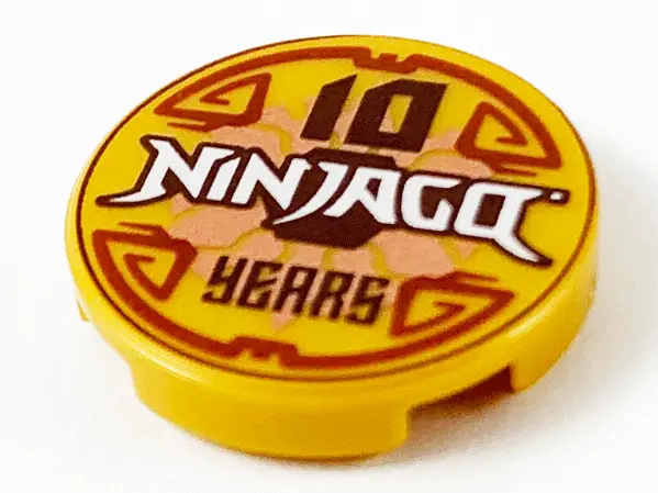 Pearl Gold Tile, Round 2 x 2 with Bottom Stud Holder with '10 NINJAGO YEARS' Pattern