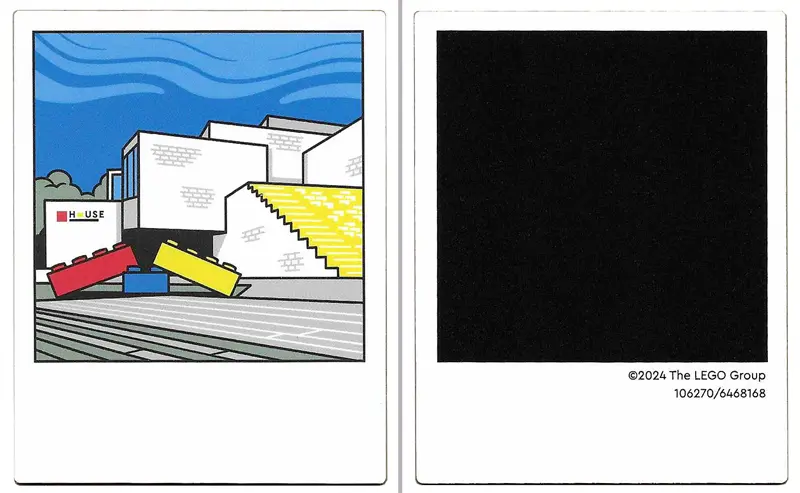 White Plastic Polaroid Photo with White LEGO House Building with Red, Yellow, and Blue Bricks and Bl