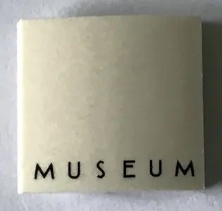 White Slope, Curved 2 x 2 x 2/3 with 'MUSEUM' Pattern