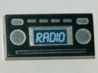 Black Tile 1 x 2 with Light Blue 'RADIO' and Silver Buttons Pattern