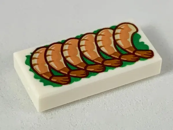 White Tile 1 x 2 with 6 Shrimp on Green Garnish Pattern