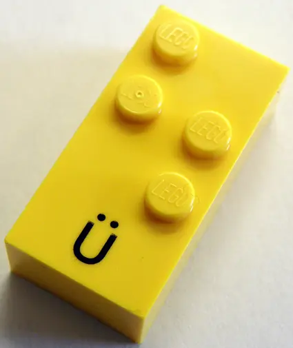 Yellow Brick, Braille 2 x 4 with 4 Studs with Black Capital Letter U with Diaeresis (Ü) Pattern (dot
