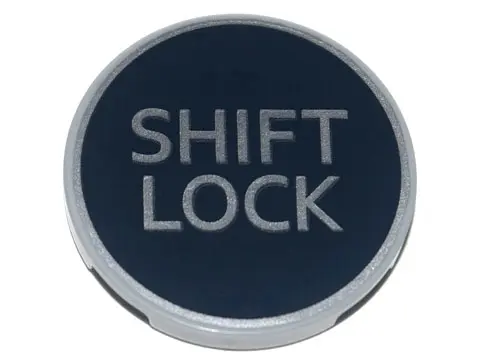 Light Bluish Gray Tile, Round 3 x 3 with Silver 'SHIFT LOCK' on Black Background Pattern