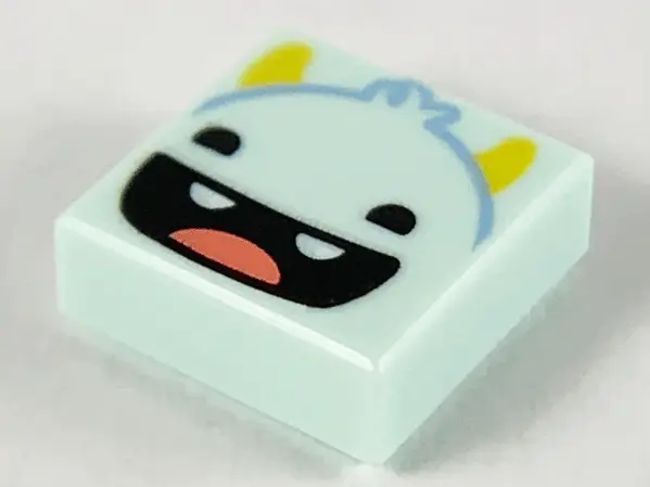 Light Aqua Tile 1 x 1 with Smiling Monster Face, Yellow Horns, Black Eyes, Open Mouth, 2 Teeth and R