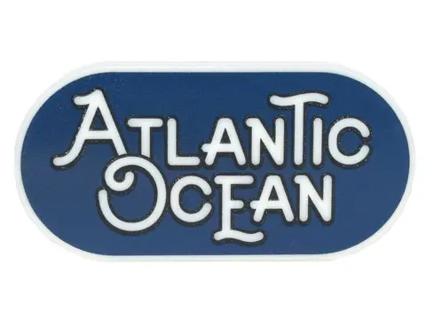 Glow In Dark White Tile, Round 2 x 4 Oval with Black Outline 'ATLANTIC OCEAN' on Dark Blue Backgroun