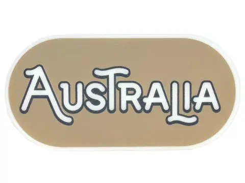 Glow In Dark White Tile, Round 2 x 4 Oval with Black Outline 'AUSTRALIA' on Dark Tan Background Patt
