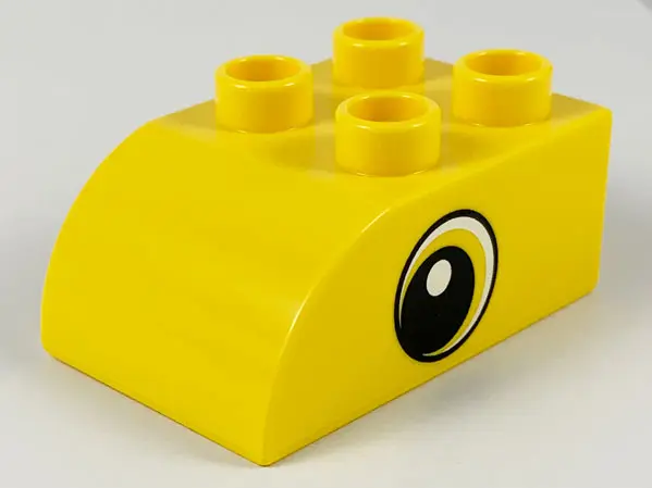 Yellow Duplo, Brick 2 x 3 Slope Curved with Circled Black Eye with Crescent and White Pupil Pattern 