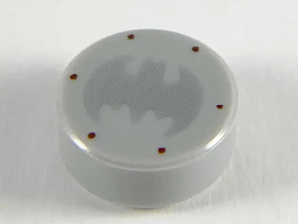Light Bluish Gray Tile, Round 1 x 1 with Silver Bat Batman Logo and 6 Reddish Brown Rivets Pattern